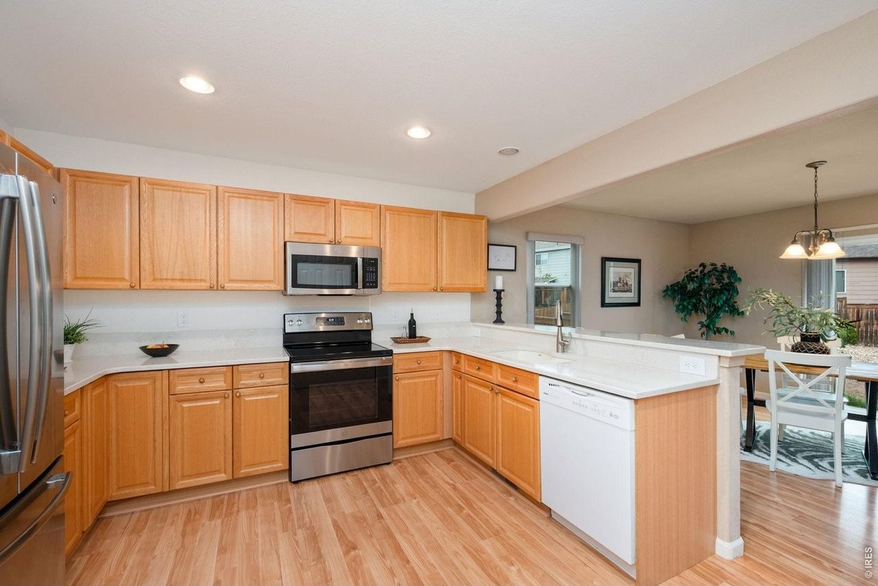 Kitchen with quartz counters, breakfast bar and stainless range and microwave