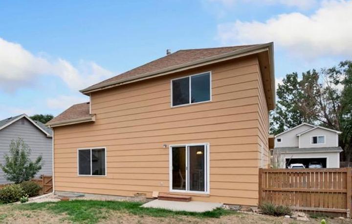 Back of the home with the fenced yard